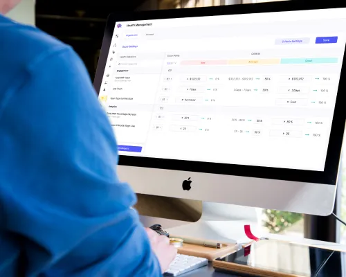 Customer health management grid on a desktop monitor.